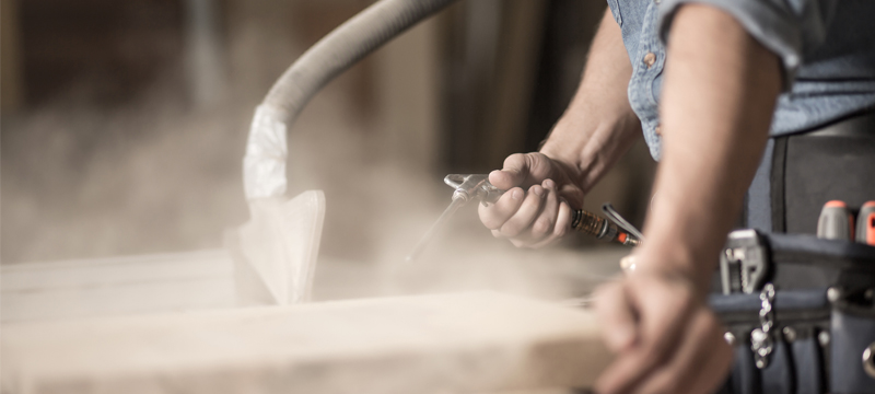 Professional generating dust in a workshop