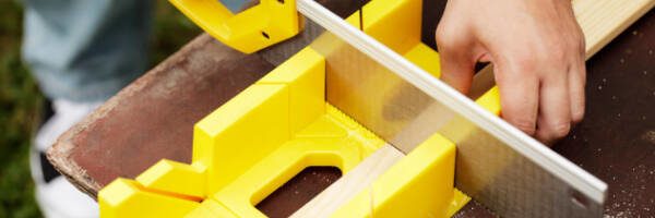 woodworker using a miter box